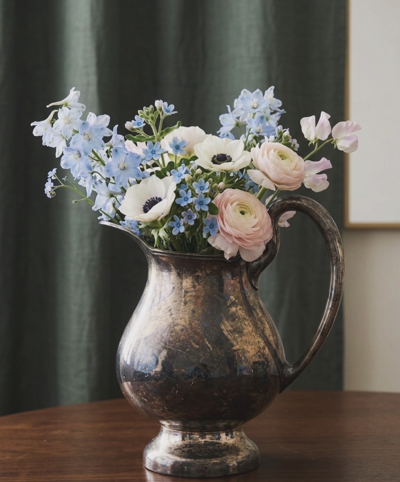 Vintage silver pitcher with pink, white, and blue flowers